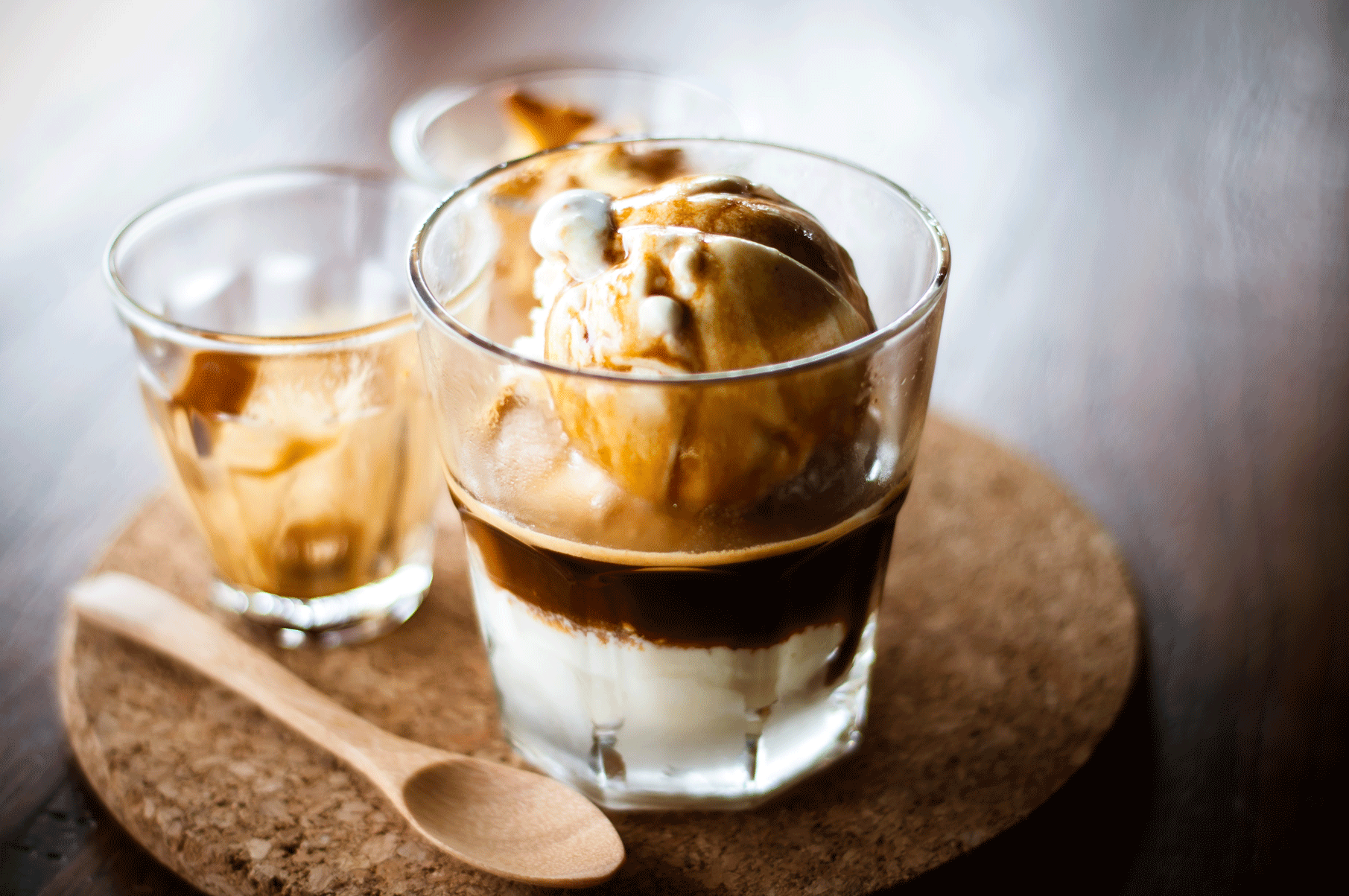 two glasses of ice cream on a wooden table