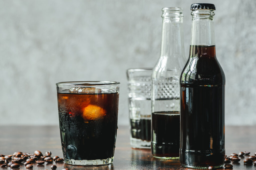 A table topped with bottles and glasses filled with liquid