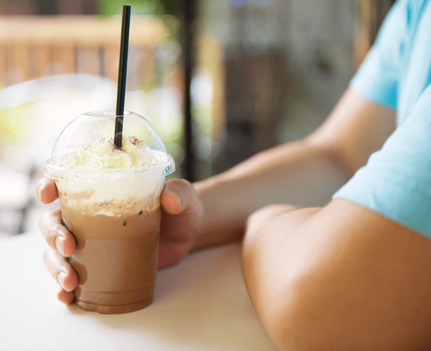 a person holding a drink in their hand