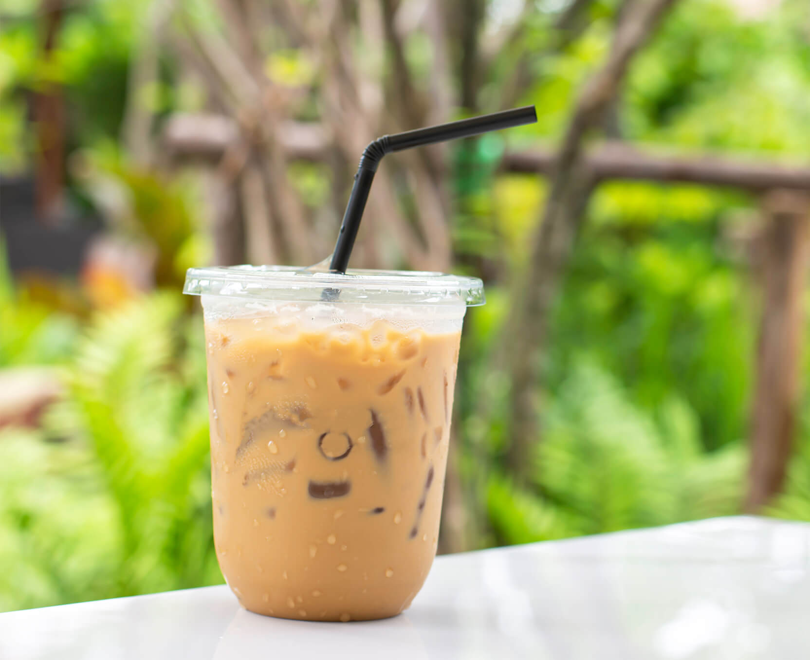 a cup of coffee with a smiley face drawn on it